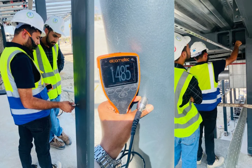 Inspector measuring dry film thickness of a coating with a DFT gauge on a steel column